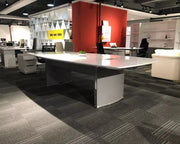 Modern silver-gray executive conference table with curved legs and reflective surface for luxury office meetings