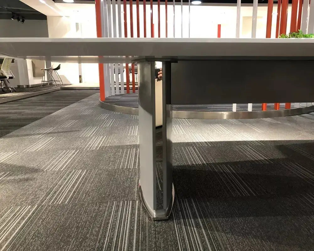 Modern gray metal table leg with a sleek angular design and polished finish for executive 12 person conference table