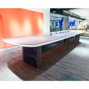 Modern grey office meeting table with sleek white top dark metallic legs power railing and high-density fiber durability
