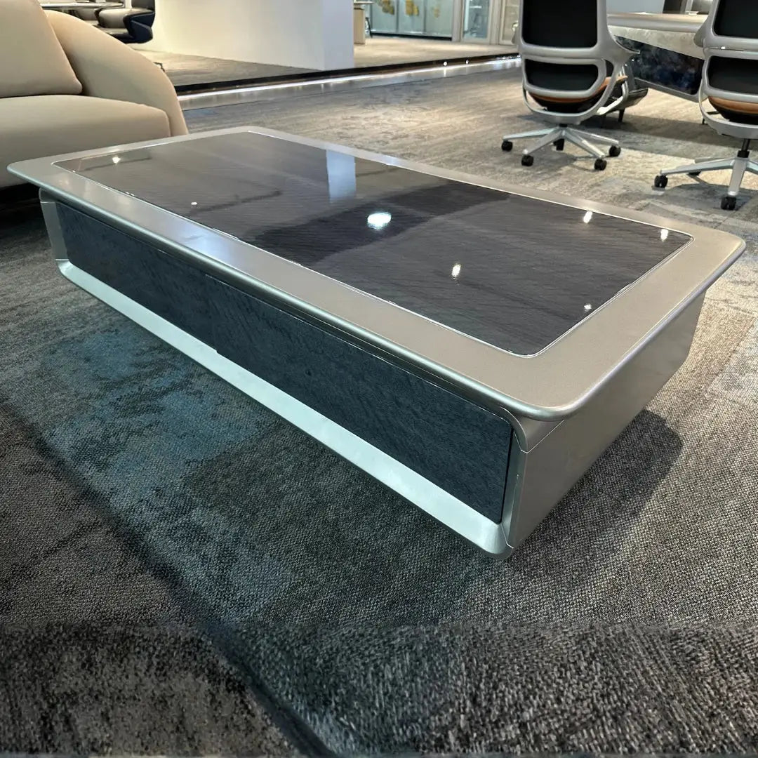 Luxury modern executive coffee table with a sleek silver metallic frame and dark glossy glass top 140 x 70 x 45 cm