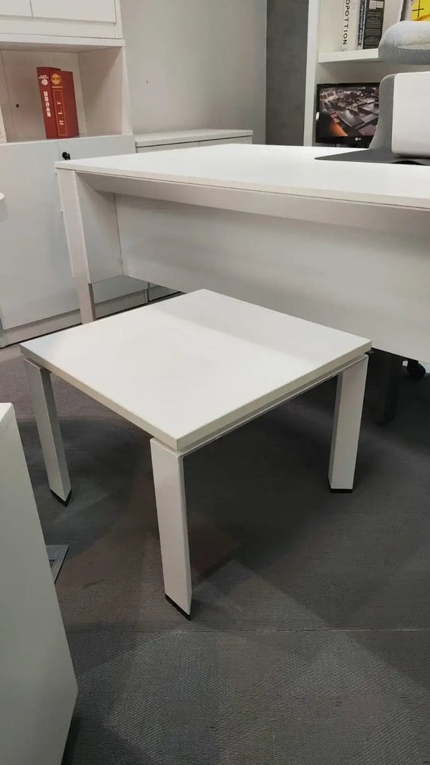 Modern white square coffee table with sleek minimalist design and thin legs measuring 50x50x50 centimeters